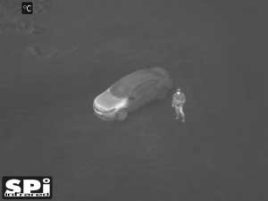 White hot FLIR UAV drone security image of parking lot surveillance