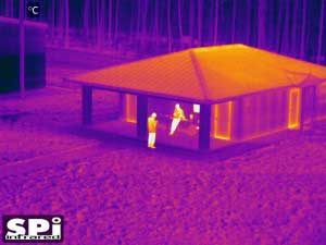 UAV thermal drone image of people by a cabin